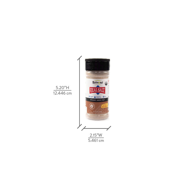 A shaker of Redmond Real Salt organic garlic salt stands against a white background, showcasing its label and size dimensions.