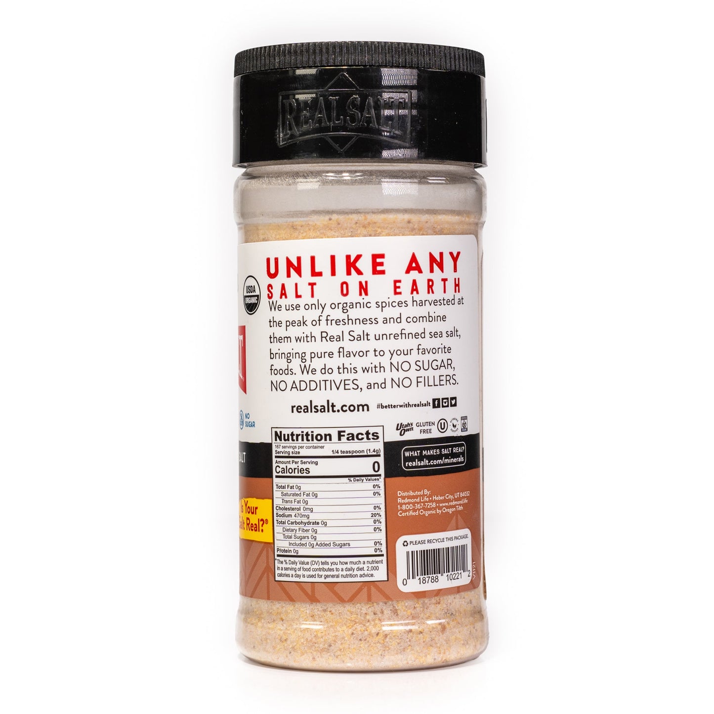 Clear shaker of Real Salt brand organic seasoned salt on a white background, showcasing the nutritional information and company branding.